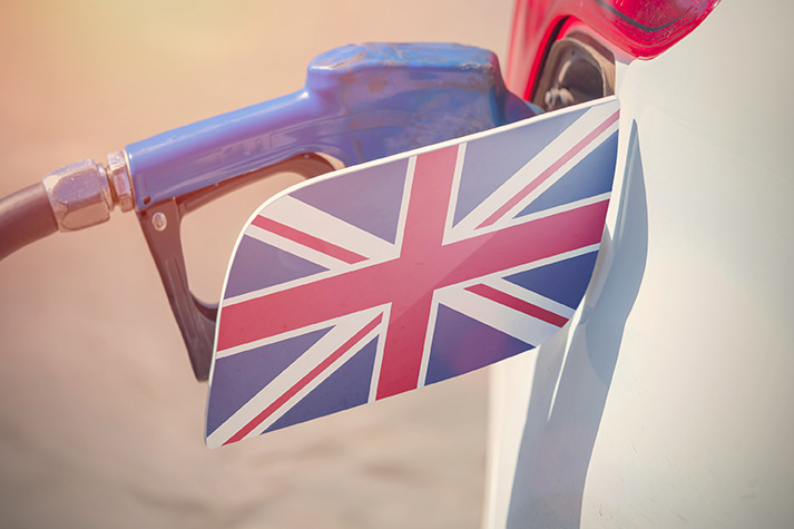Flag of United Kingdom Great Britain on the car's fuel filler flap with gas pump nozzle in the tank