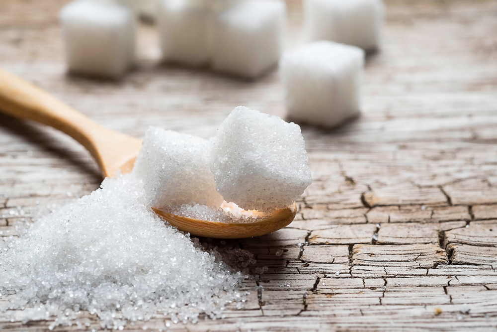 White,Sugar,In,Wood,Spoon,On,Wood,Table