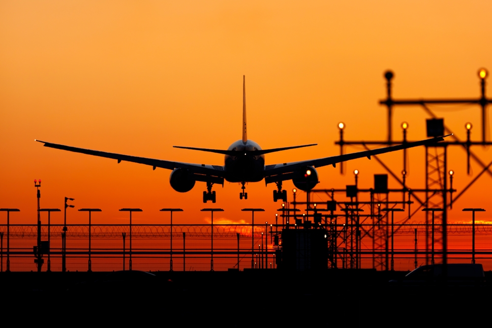Airplane,Landing,On,The,Background,Lights,And,Sunset Airplane,Landing,On,The,Background,Lights,And,Sunset
