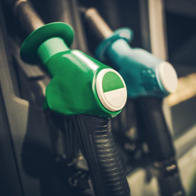 Gasoline Pump Nozzles Closeup Photo. Gas Station Equipment. Car Refuel Concept