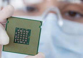 Close-up,Of,Female,Surgeon,Holding,A,Processor,Against,White,Background