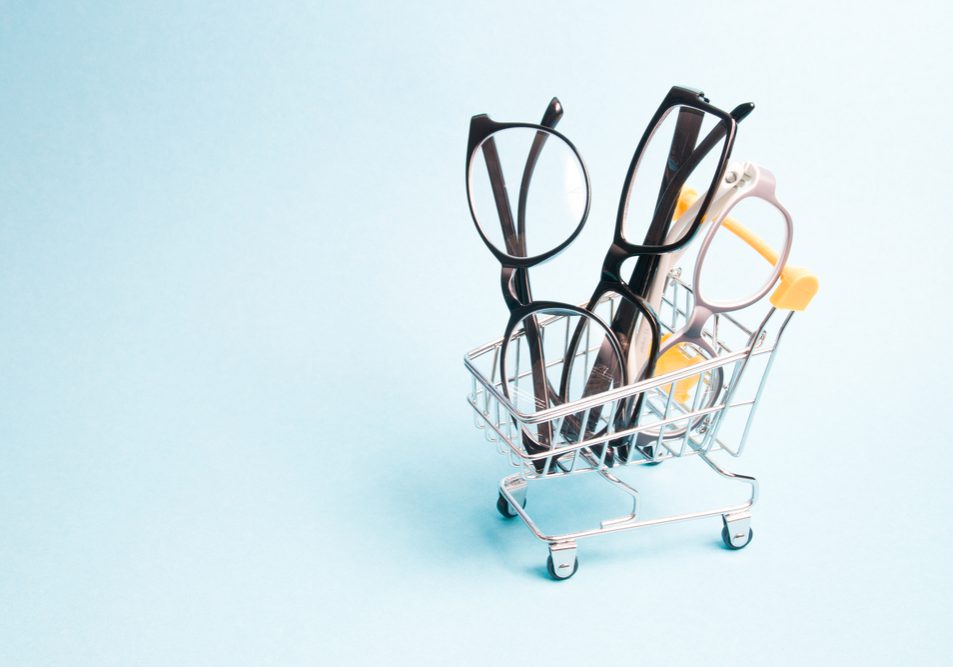 Eyeglasses,In,A,Small,Shopping,Trolley,,Blue,Background,,Copy,Space,